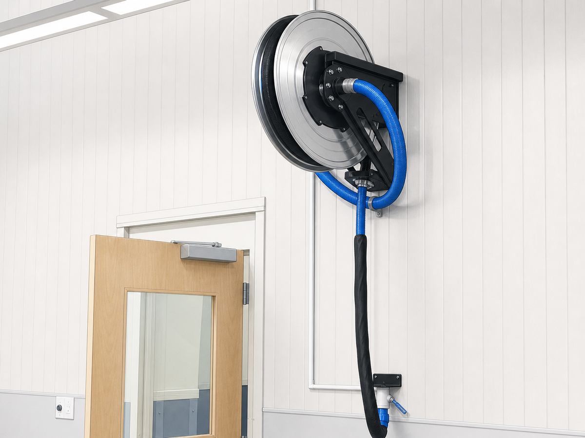 Illustrated wall-mounted hose reel in a veterinary facility.
